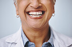 Dental, smile and elderly woman in studio for mouth, hygiene and denture care against grey background. Teeth whitening, cleaning and senior lady happy for oral, tooth and natural looking veneers