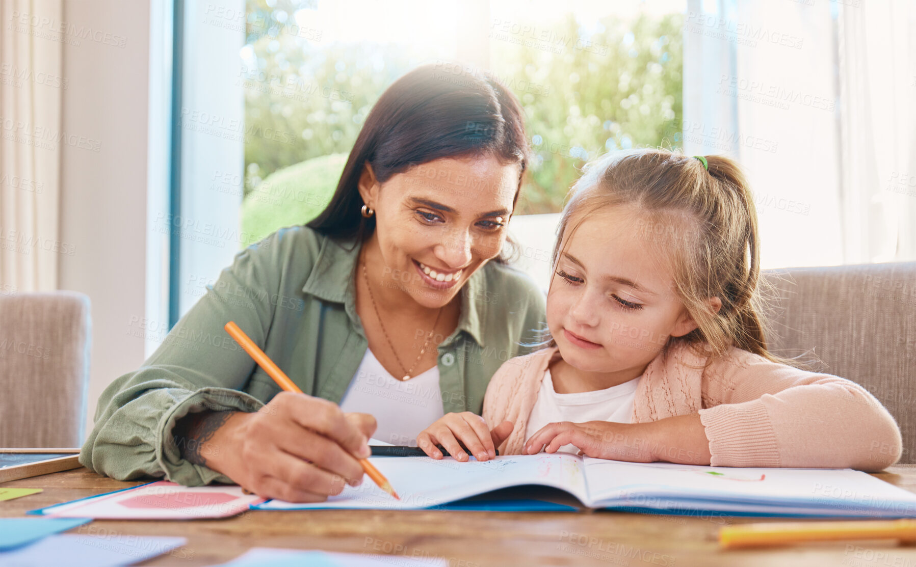 Buy stock photo Writing, helping and happy mother with girl for home education, language support and creative development.  Family, biracial mom or woman teaching child, learning and drawing in book for creativity