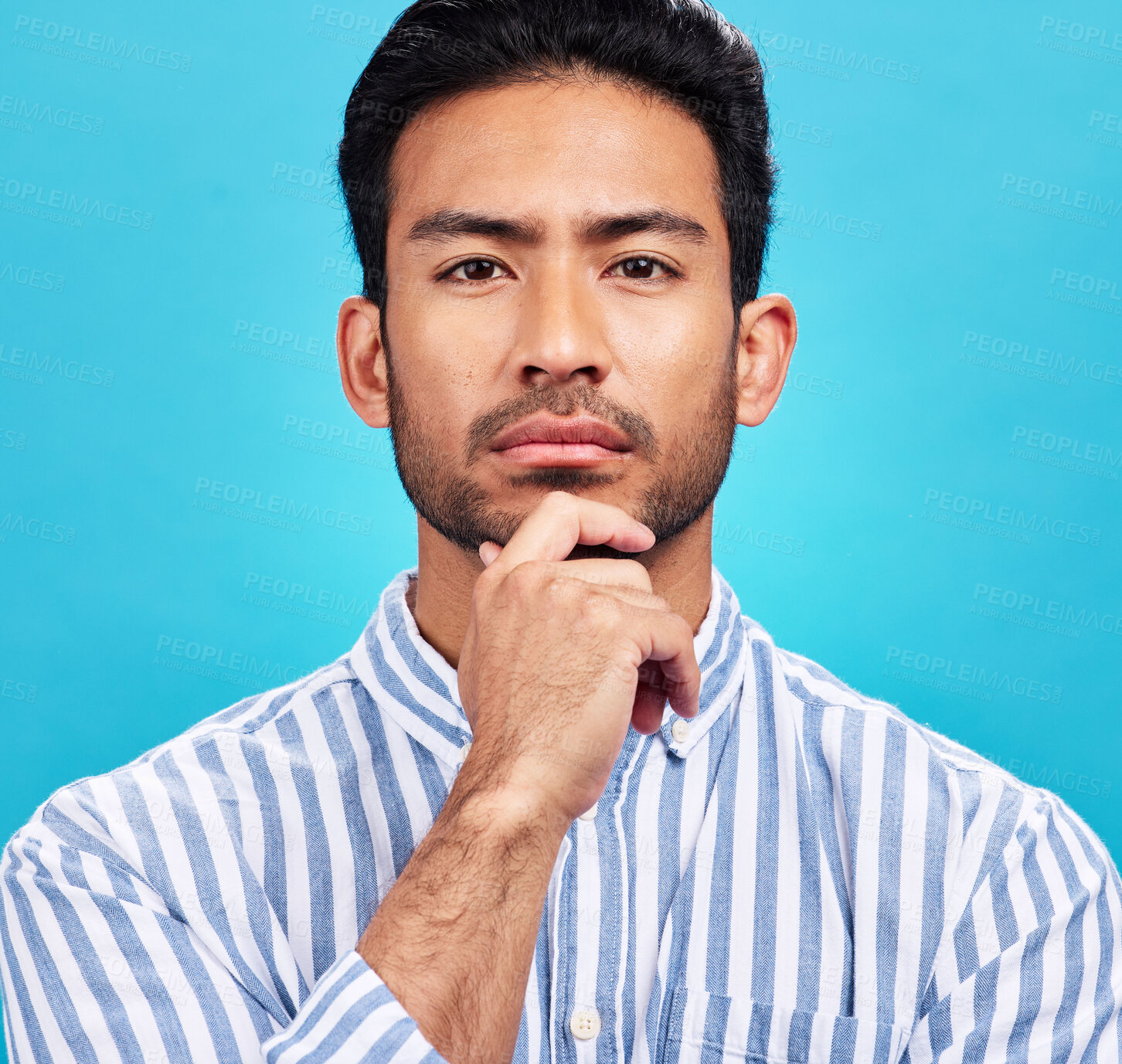 Buy stock photo Portrait of man on blue background, thinking and serious expression and hand on face isolated on studio backdrop. Confidence, mockup space and professional male model with pride and vision for future