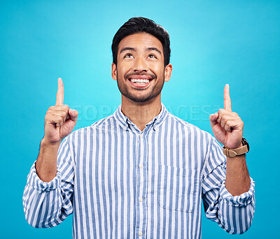 Buy stock photo Man is pointing up, marketing and promotion with happiness and branding isolated on blue background. Opportunity, deal or announcement with advertising, news and promo ad with male person and smile