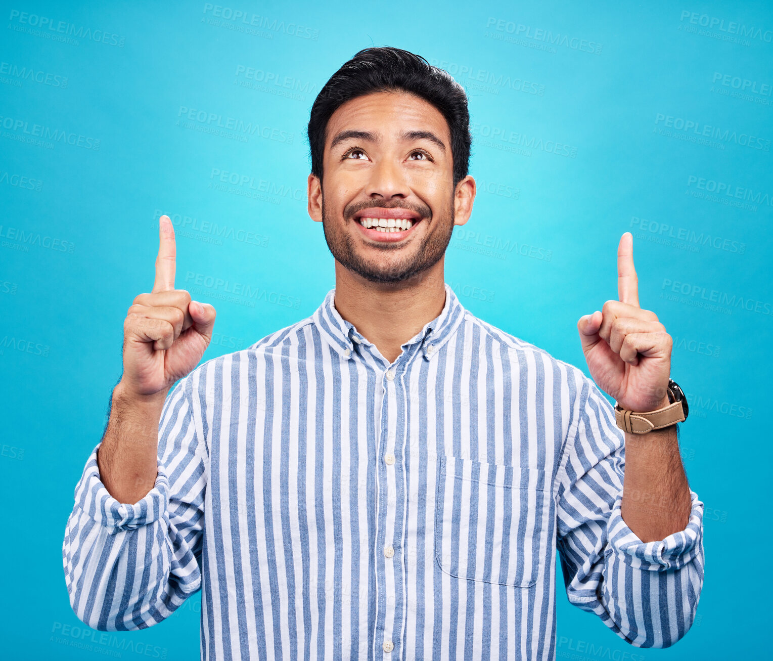 Buy stock photo Man is pointing up, marketing and promotion with happiness and branding isolated on blue background. Opportunity, deal or announcement with advertising, news and promo ad with male person and smile