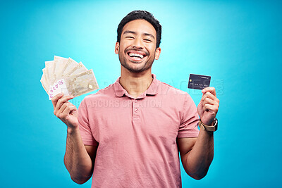 Buy stock photo Money, portrait and credit card by happy man in studio with savings, finance or investment growth on blue background. Cash, face and asian guy smile for banking, success or financial freedom isolated