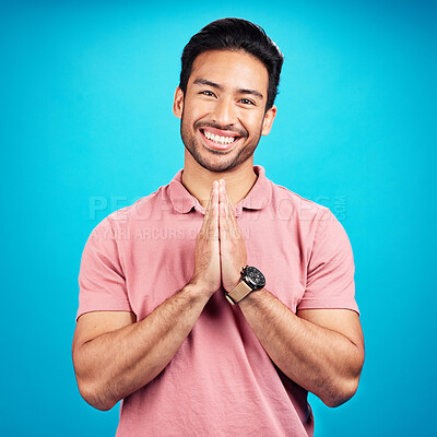 Buy stock photo Happy, prayer hands and portrait of a man in a studio with a peaceful, positive and good mindset. Happiness, smile and face of a male model with a grateful hand gesture isolated by a blue background.