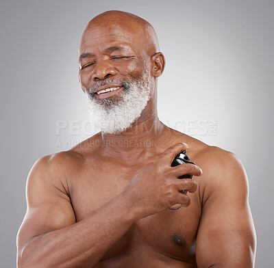 Buy stock photo Perfume, smile and senior black man model closed eyes, happy and excited isolated in a gray studio background. Self care, skincare and old male person holding cologne for fragrance in backdrop