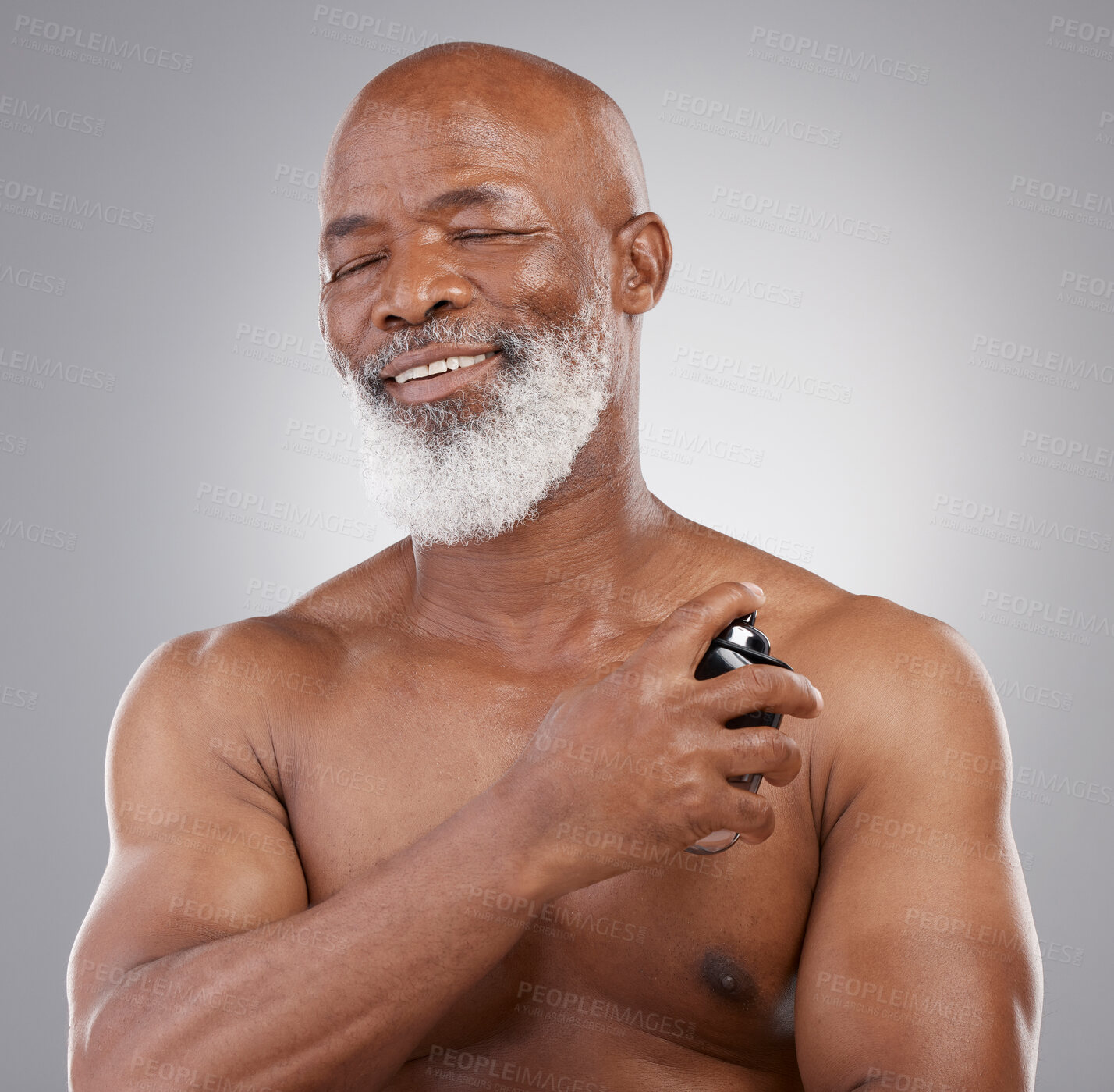 Buy stock photo Perfume, smile and senior black man model closed eyes, happy and excited isolated in a gray studio background. Self care, skincare and old male person holding cologne for fragrance in backdrop