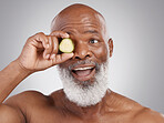 Senior black man, smile and cucumber for skincare, natural nutrition or health against a gray studio background. Happy African American male with vegetable citrus for healthy skin, diet or wellness