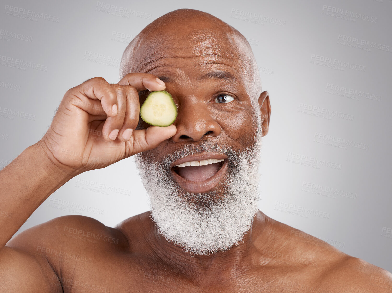 Buy stock photo Senior black man, smile and cucumber for skincare, natural nutrition or health against a gray studio background. Happy African American male with vegetable citrus for healthy skin, diet or wellness