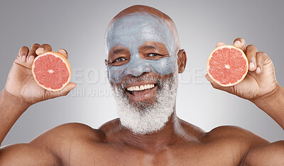 Buy stock photo Senior black man, grapefruit and portrait in skincare, vitamin C or natural nutrition against a gray studio background. Happy African male smile with fruit and face mask for healthy skin or wellness