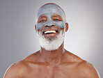 Skincare, clay mask and portrait of black man with smile, happiness and anti ageing treatment on studio background. Dermatology, cosmetic process and happy, mature model in charcoal skin care facial.
