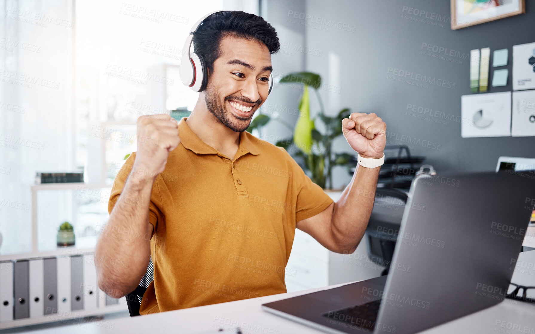 Buy stock photo Business man, laptop and headphones to celebrate success while listening to music, audio or video call. Asian male entrepreneur at desk with a smile and hands for achievement, notification or goals