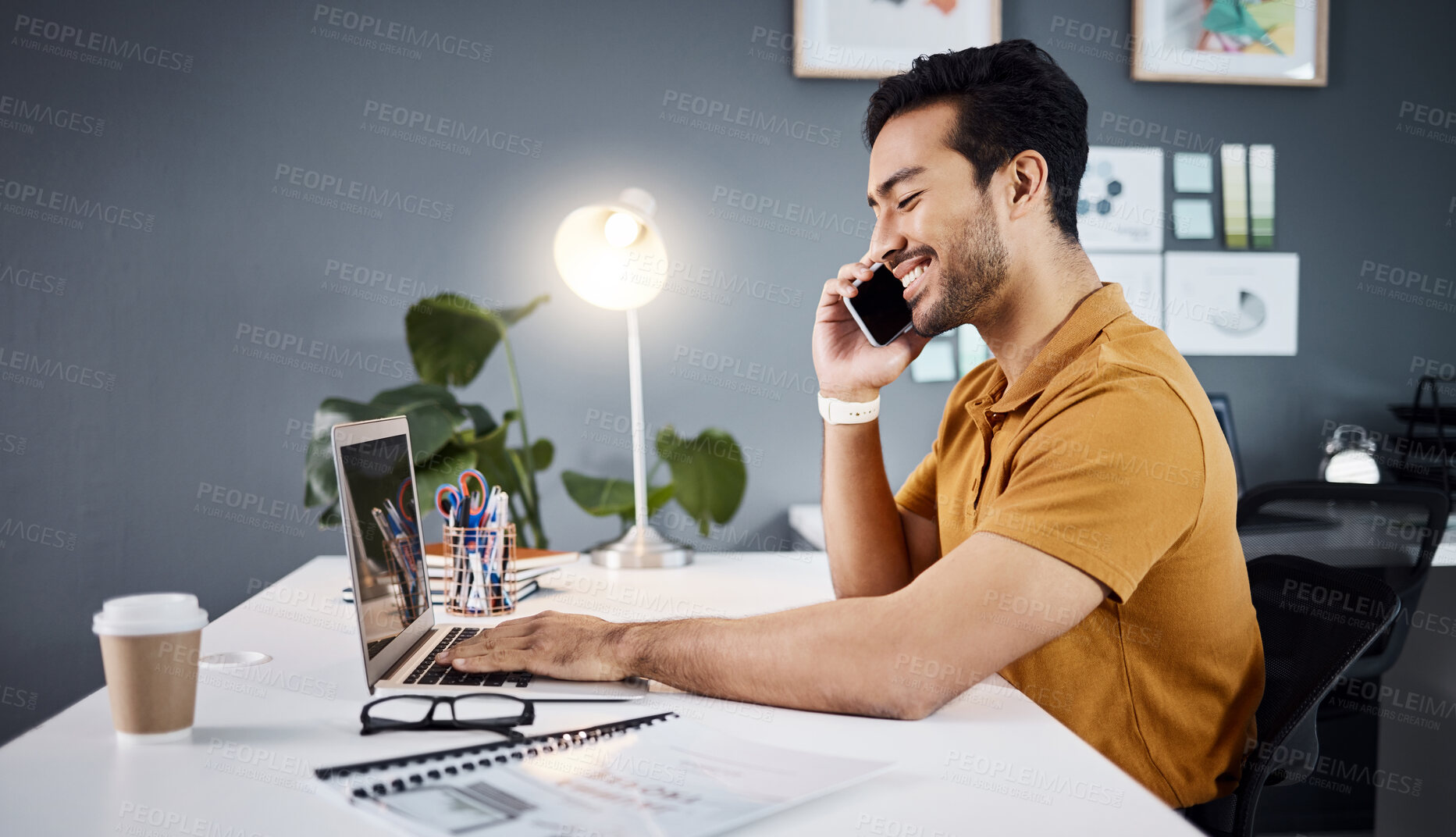 Buy stock photo Laptop, phone call and Asian man with a smile, business and communication in workplace. Male employee, entrepreneur and creative with coffee, smartphone and connection for discussion and planning