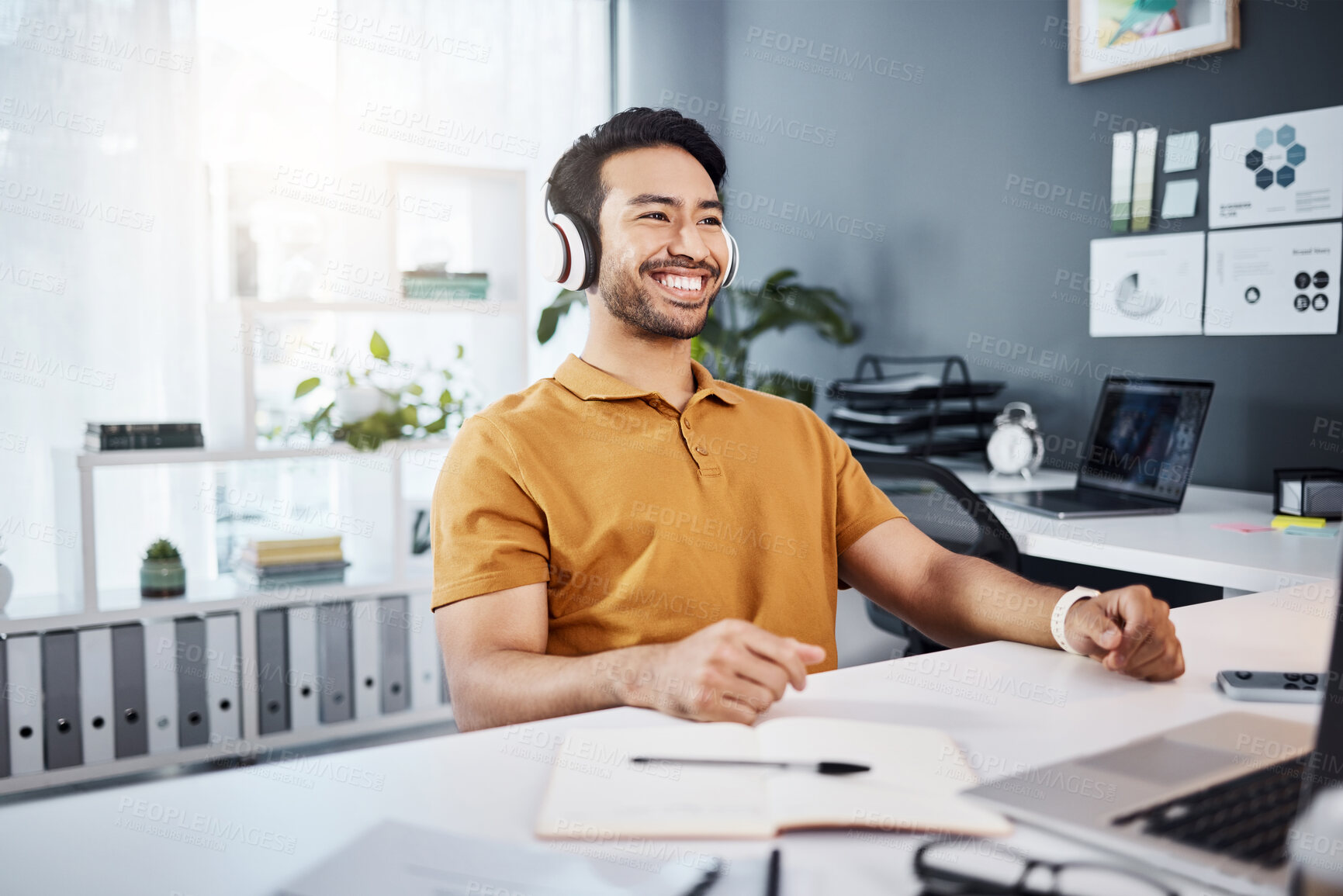 Buy stock photo Business man, smile and thinking with headphones while listening to music, audio or podcast in office. Asian male entrepreneur at desk while excited for idea, plan or goals at a modern workplace