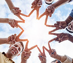 Hands, star and low angle circle for business people with icon for motivation, support and goals by sky. Businessman, women and solidarity for diversity, vision and progress with teamwork at company