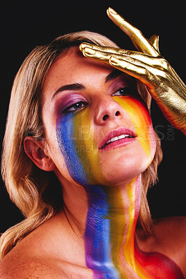 Buy stock photo Woman, beauty face and gold color paint and cosmetics on skin in studio. Female model person on a black background for art deco, fantasy and creative rainbow makeup with metallic hand on head