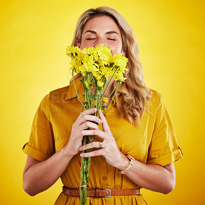 Buy stock photo Portrait, smelling and woman with flowers in studio isolated on a yellow background. Floral, bouquet and person sniff, aroma or scent with female model holding natural plants and fresh flower.