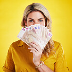 Portrait, euros and woman with money fan in studio isolated on a yellow background. Winner, financial freedom and rich female person with cash profit after winning lottery, bonus prize or competition