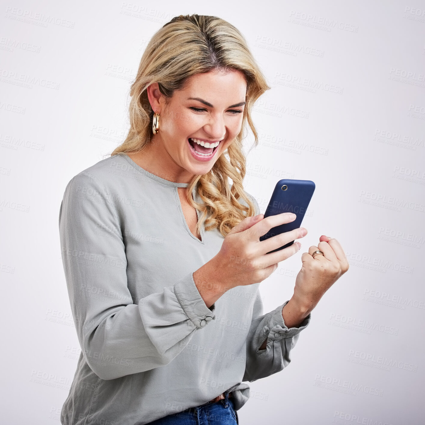 Buy stock photo Happy woman, phone and celebration for winning, good news or sale against a white studio background. Excited female with smile on mobile smartphone app in win, discount or bonus promotion and victory