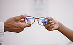 Glasses, optometry and hands of an optometrist and person for decision, buying and help with vision. Consulting, helping and an optician giving eyewear frames and prescription lenses to a customer