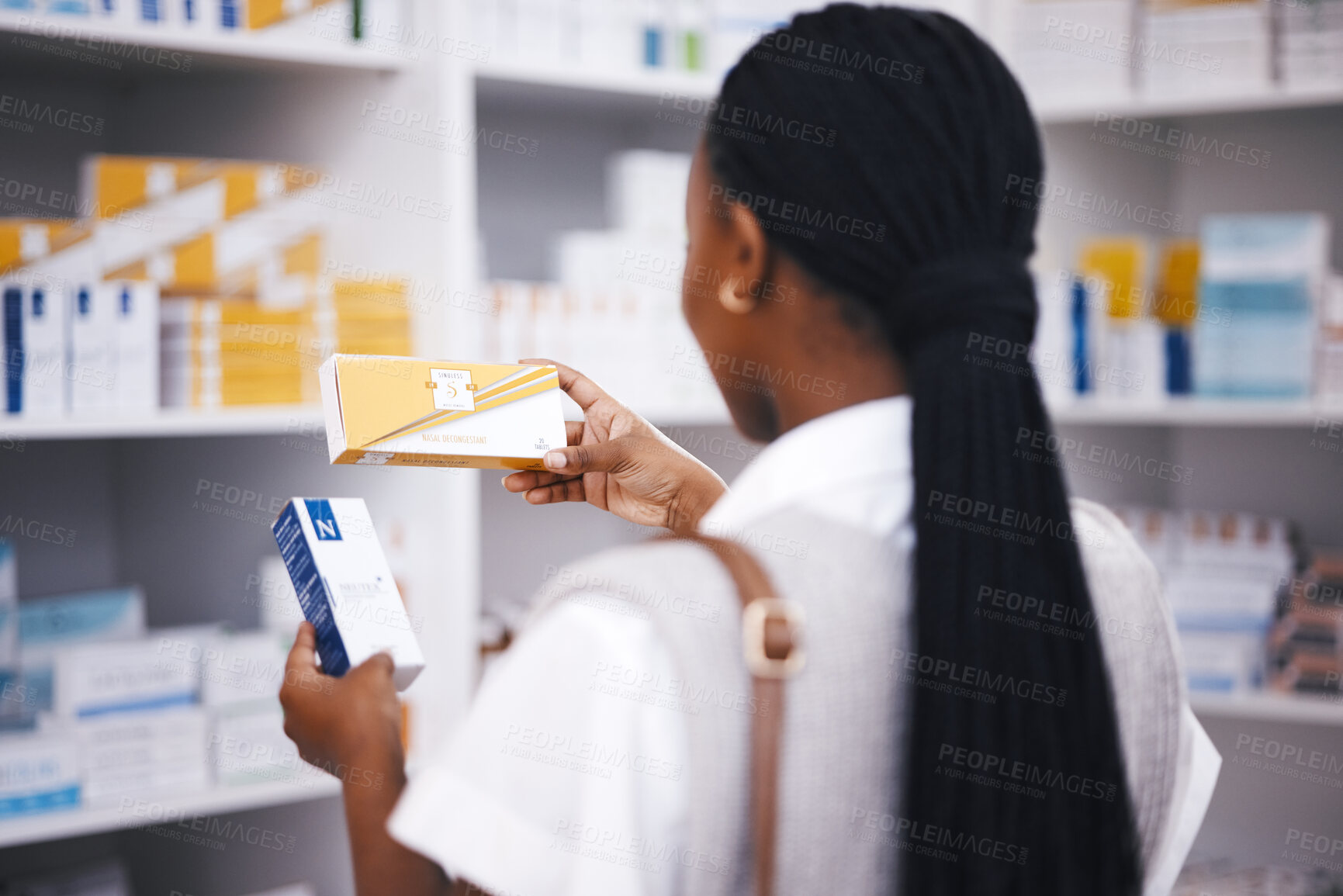 Buy stock photo Pharmacy stock, woman and medicine check of a customer in a healthcare and wellness store. Medical, inventory and pharmaceutical label information checking of a black female person back by shop shelf