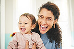 Mother, laughing baby and a happiness in a family home while together for love, support and care. Woman or mom and girl child laugh for funny or comic joke for quality time, bonding and to relax