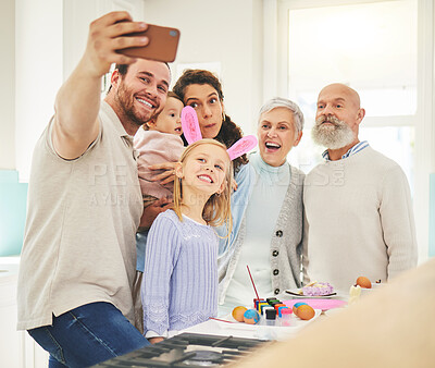 Buy stock photo Easter selfie, big family and smile while painting, holiday bonding and memory together at home. Happy, festive and a father taking a photo with children, mother and senior parents with an activity