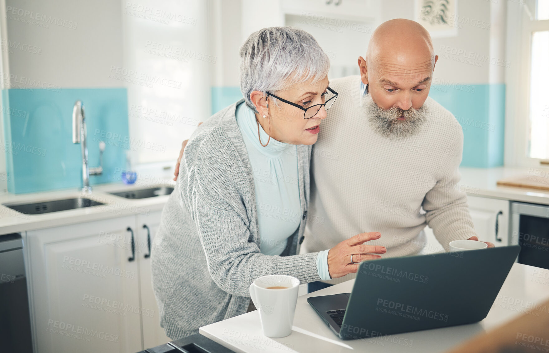 Buy stock photo Laptop, elderly couple and coffee in kitchen, internet browsing or social media in home. Computer, retirement and man and woman reading email, news or streaming video, movie or film together online.