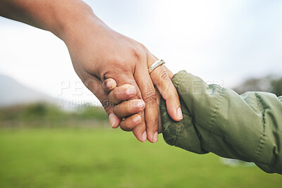 Buy stock photo Closeup, mother and child holding hands in park, morning walk and bonding with trust, support and love. Woman, kid and helping hand walking in nature for quality time in sunshine and holiday together