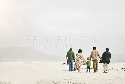 Buy stock photo Children, holding hands and family walking at the beach in winter for quality time, love and care outdoor. Men, women or grandparents with parents and kids with mockup on a travel vacation in winter