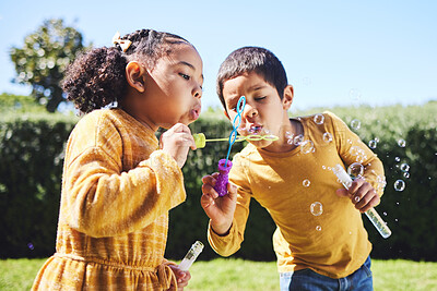 Playing, garden and children blowing bubbles for entertainment, weekend activity and fun together. Recreation, outdoors and siblings with a bubble toy for leisure, childhood and enjoyment in summer