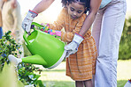 Children, watering plants and a mother teaching her daughter about growth or sustainability in the garden. Family, spring or gardening with a woman and female child outdoor in the backyard together