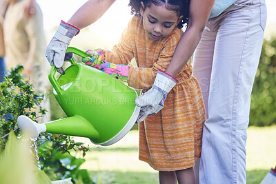 Buy stock photo Children, watering plants and a mother teaching her daughter about growth or sustainability in the garden. Family, spring or gardening with a woman and female child outdoor in the backyard together