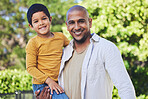 Portrait, son and father with a smile, outdoor and bonding with happiness, family and cheerful. Face, parent and dad with boy, love or embrace in nature, outside and affection with joy, park or relax