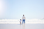 Father, son and beach with back, space and mock up with blue sky, lens flare and bonding with love in summer. Papa, male kid and holding hands for care, vacation and sea mockup with waves in sunshine