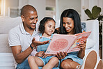Parents, family and girl reading book in home, bonding and learning in living room. Storytelling, father and happiness of mother with kid for education, homeschool and studying in lounge together.