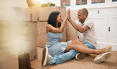 Buy stock photo Happy couple, high five and moving in new home for real estate purchase, property or homeowner. Woman and man touching hands in happiness on floor for mortgage loan, finance or relocation with boxes
