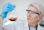 Woman, chemical test and science research or medical analysis in a laboratory for investigation or study. Face of a scientist person with liquid, goggles and flask for future medicine or innovation