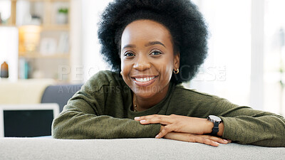 Face of a happy woman relaxing indoors on the weekend. Beautiful, cheerful and carefree African American girl having a stressless day at home relaxing in her modern bright living room apartment