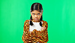 Girl child, angry face and green screen studio with arms crossed, refuse or shake head in tiger pyjamas. Frustrated kid, anger or portrait for mock up with mad, tired or bored expression by backdrop