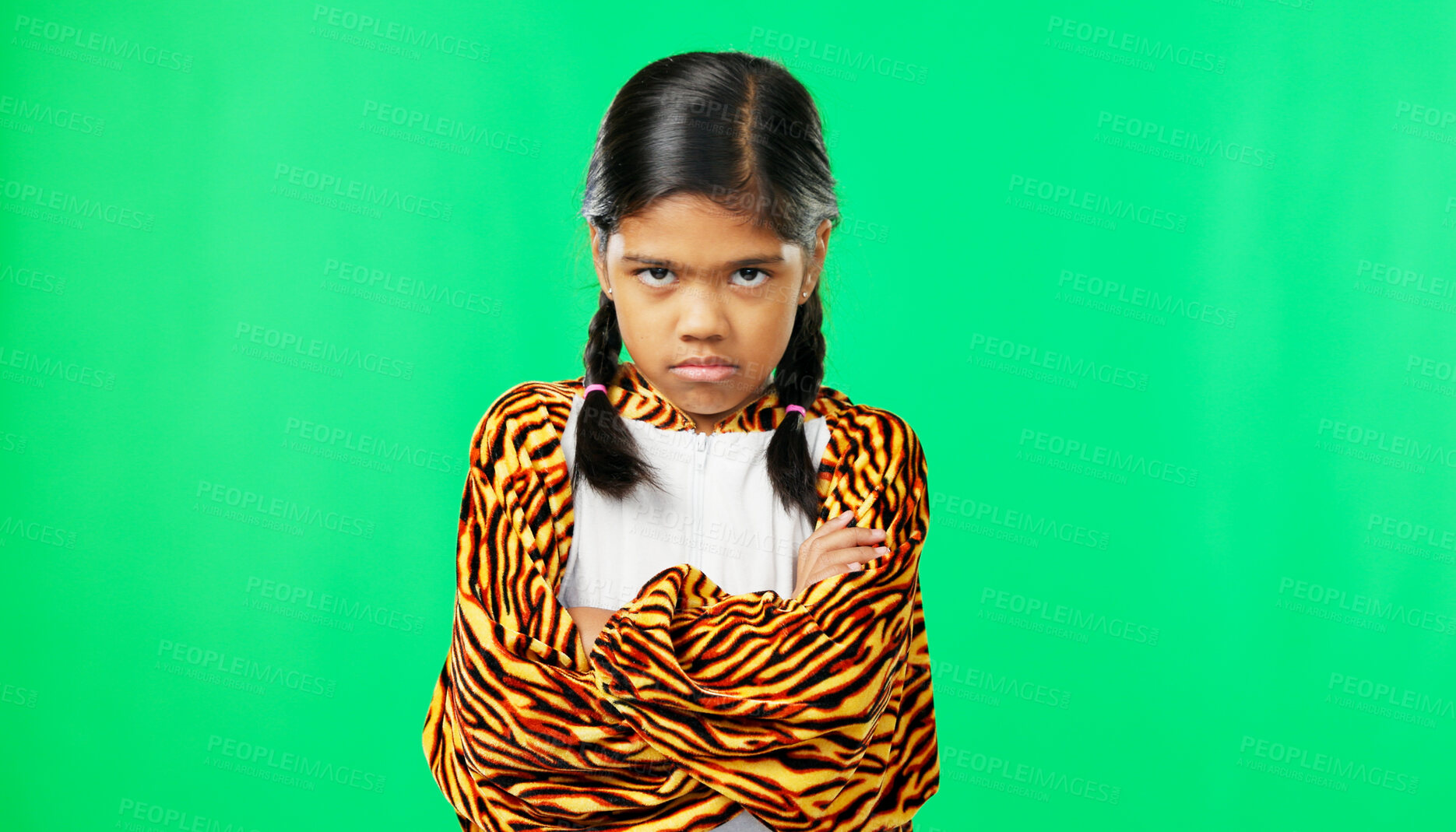 Buy stock photo Angry, face and child on green screen with arms crossed in studio with tiger pyjamas, costume or fashion. Frustrated kid or portrait of girl with upset, anger or moody body language in mock up space