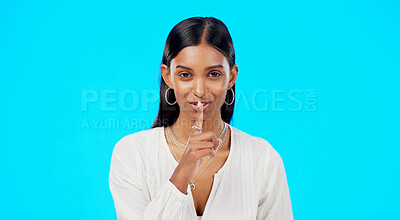 Buy stock photo Secret, face and happy woman with finger on lips in studio, blue background or privacy sign. Portrait, model and silence with shush of quiet, gossip or whisper emoji of confidential news and drama