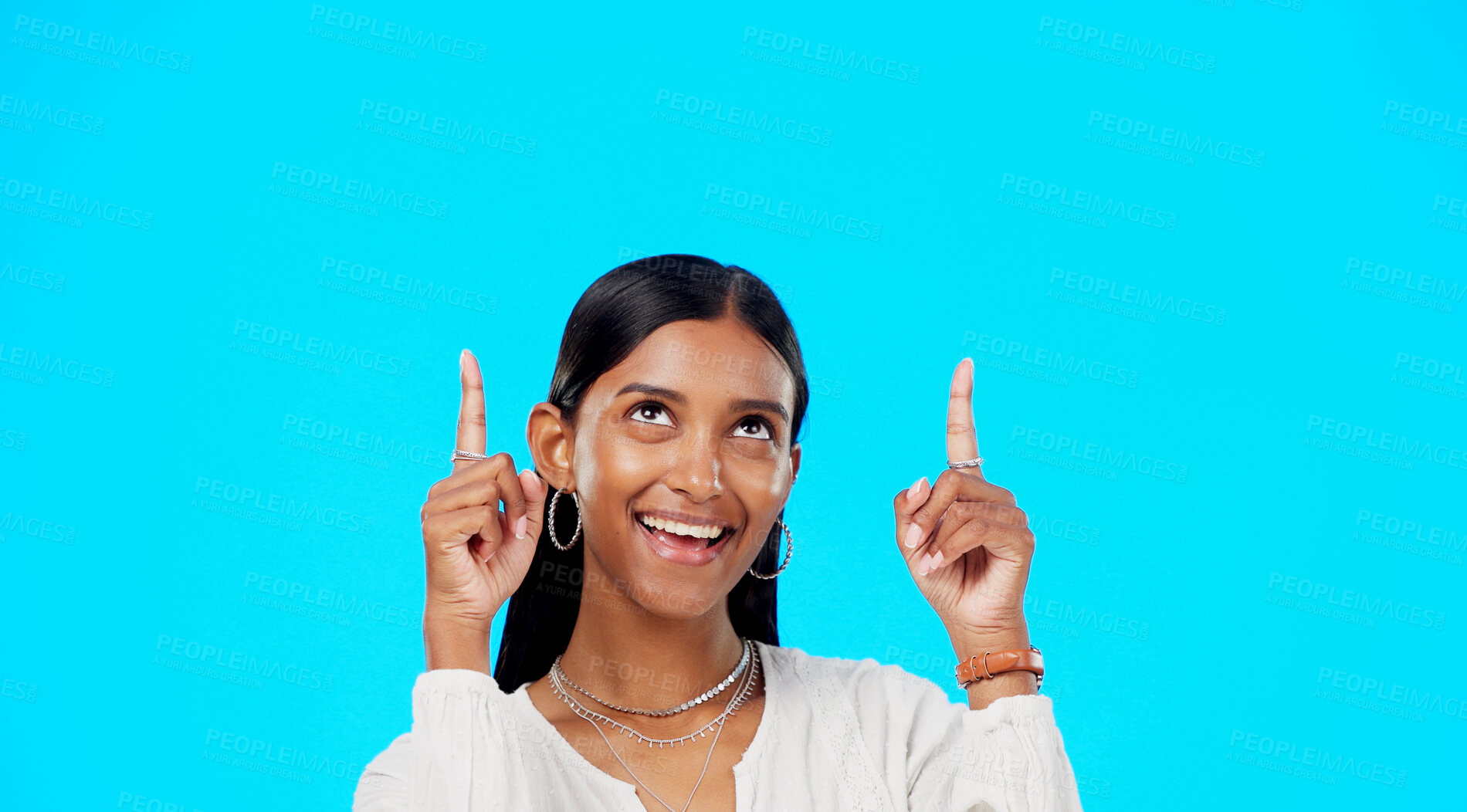 Buy stock photo Studio face, happy and woman pointing up at service deal direction, commercial ads or brand presentation space. Retail mockup, discount choice and model notification announcement on blue background