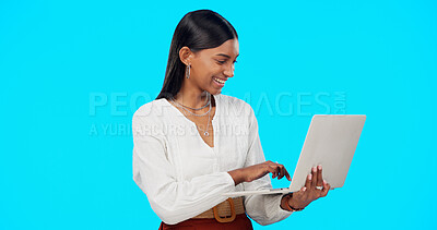 Business woman, laughing and laptop in a studio reading a funny email on computer. Isolated, blue background and young Indian female with happiness writing on a website with a smile feeling happy