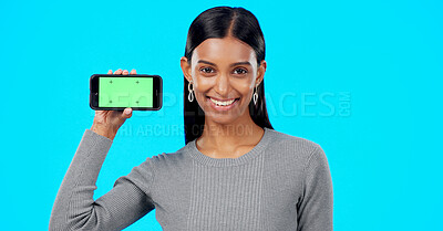 Buy stock photo Portrait, woman or advertising green screen of smartphone, newsletter or promotion coming soon in studio on blue background. Happy indian model, mobile tracking markers or launch information about us