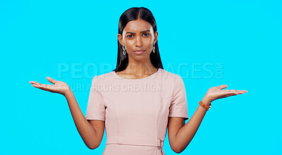 Choice, option or decision and a woman on a blue background in studio with a hand gesture. Portrait, balance and scale with an attractive young female weighing up the pros and cons of a variable