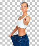 Health, weight loss and woman pointing hand with jeans and tummy tuck with skinny waist, isolated on a png background. Smile, healthcare and wellness, happy girl with liposuction, diet and big pants.