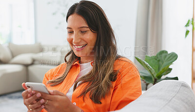 Woman, phone and laughing for funny joke, meme or social media post relaxing on living room sofa at home. Happy female chatting, texting and laugh on smartphone for fun online communication on couch