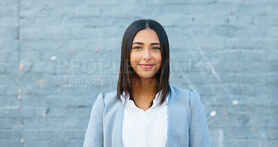 Cheerful woman smiling while standing outside against a grey wall with copy space. Happy businesswoman having fun and expressing positivity and a playful attitude