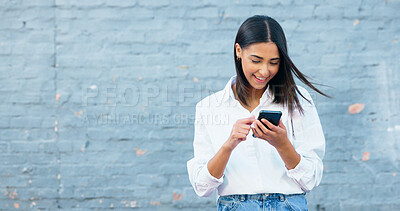 Happy young woman texting on a phone and laughing in the city. Cheerful female smiling while browsing apps, scrolling social media and searching the web online while traveling and commuting in town