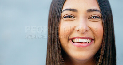 Closeup of laughing woman showing cheerful facial expression against grey wall background with copy space in city. Portrait, headshot or face of smiling, fun and trendy student giggling at funny joke