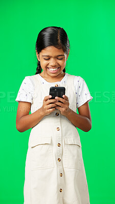 Buy stock photo Happy, child and using phone on green screen with game online for elearning or education in studio. Kid, mobile app and girl typing with cellphone, esports or smile for communication on social media 